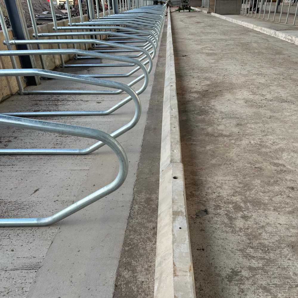 Precast concrete cubicle kerb next to cow beds