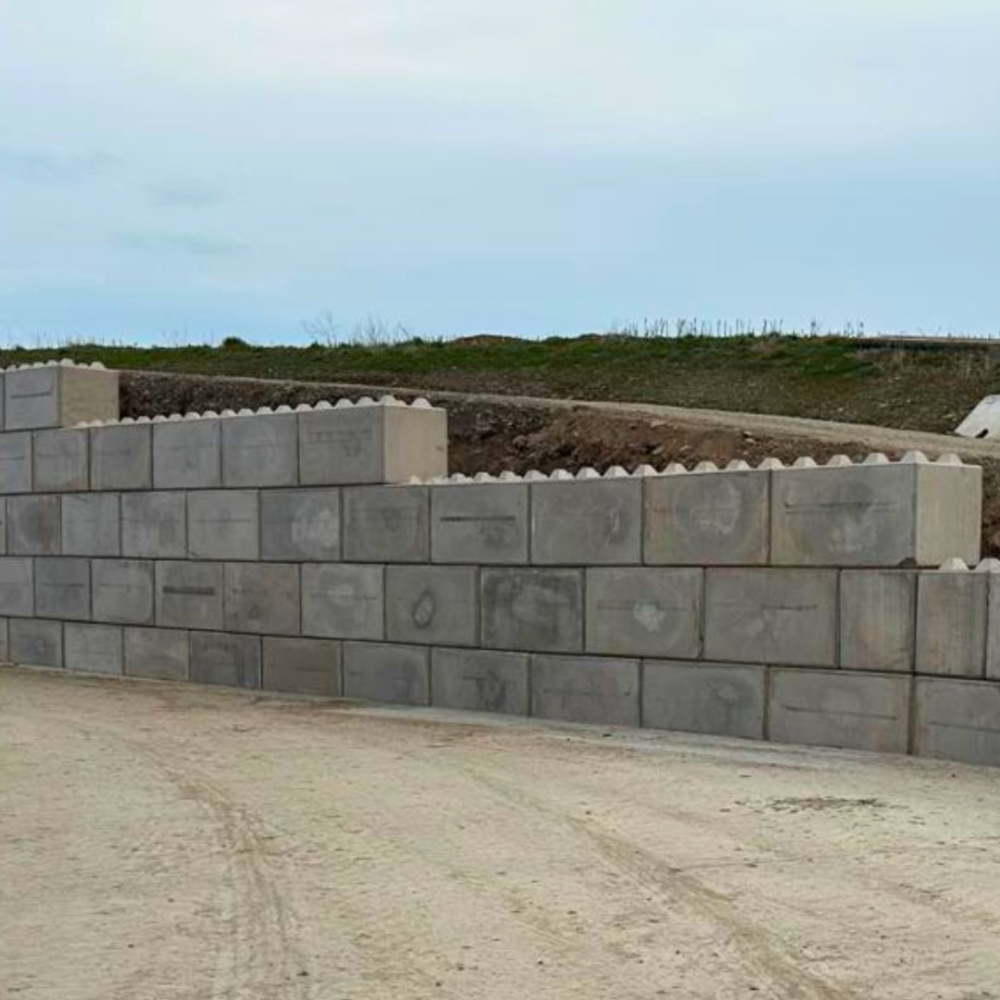 CWP precast interlocking concrete blocks used to create a retaining wall on a working farm.