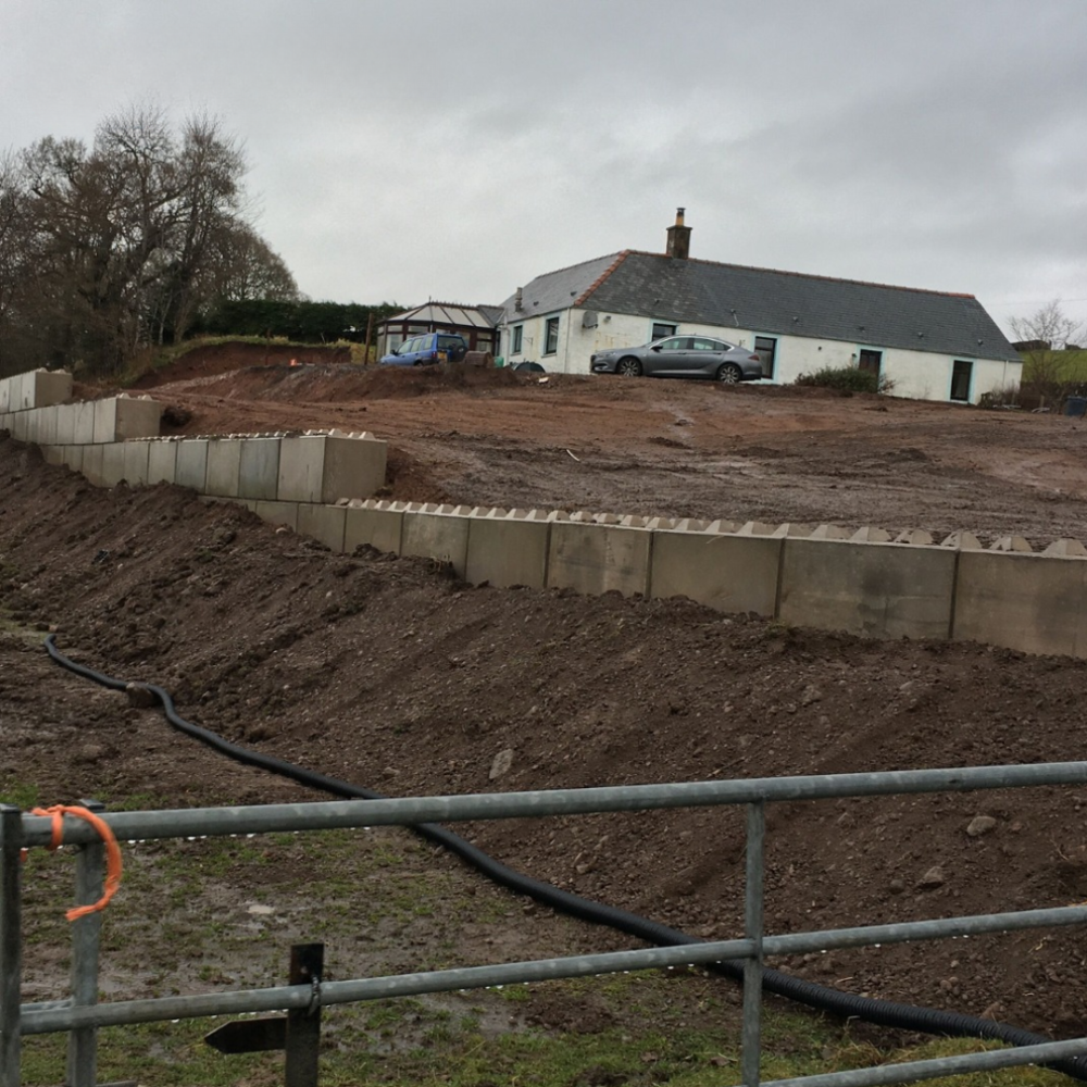 Interlocking concrete blocks forming a precast concrete retaining wall on a domestic site