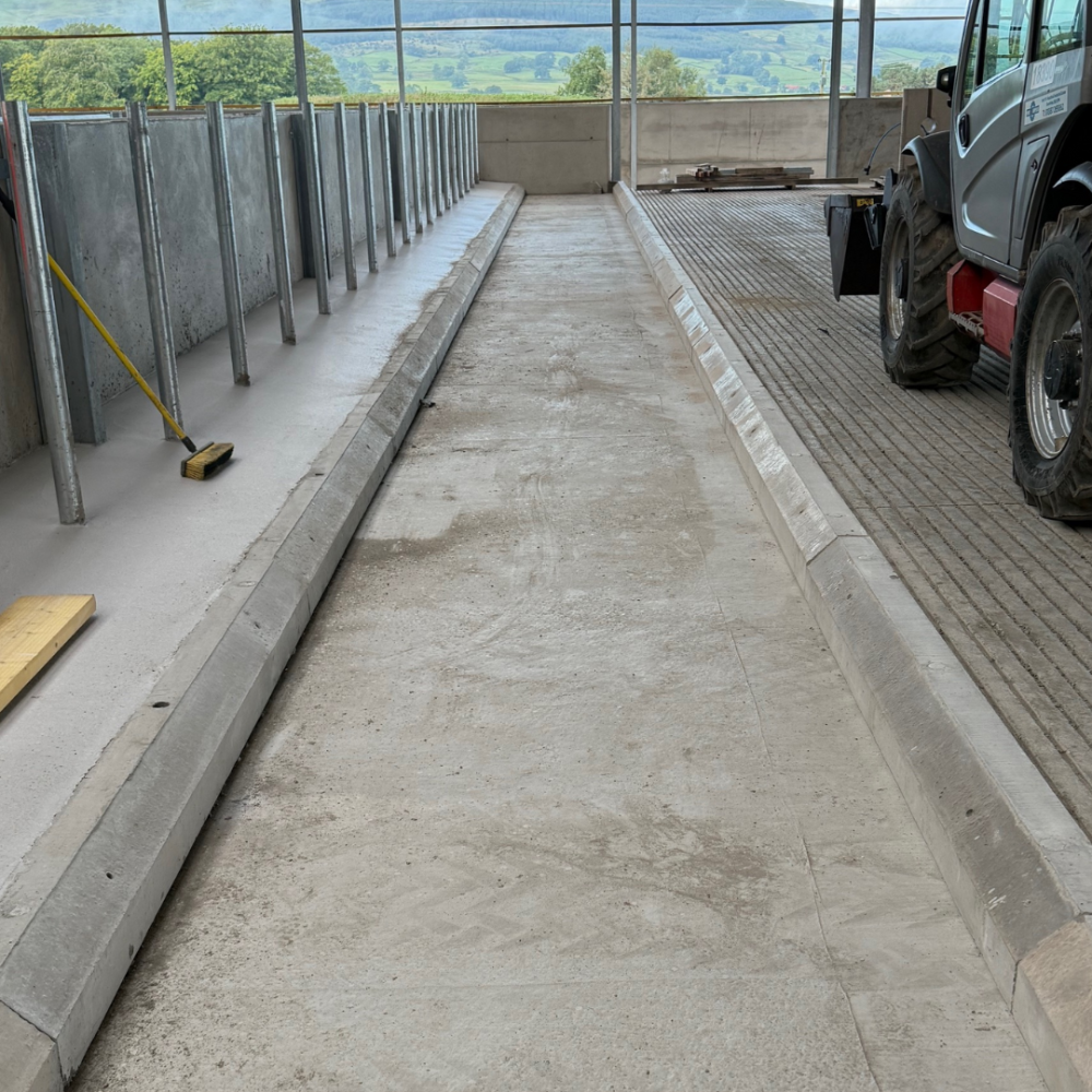 An image of a bespoke length of concrete cubicle kerbs for a cattle shed