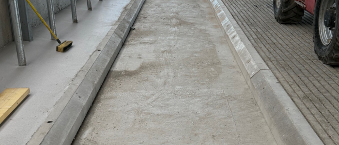 An image of a bespoke length of concrete cubicle kerbs for a cattle shed